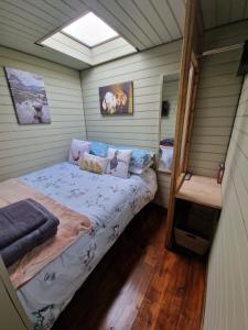 a small bedroom with a bed in a house at Stunning 1-Bed shepherd hut in Holyhead in Holyhead