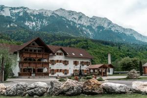 a large building with mountains in the background at Popasul Craiului in Zărneşti