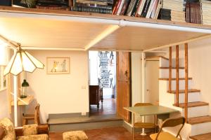 a loft apartment with a staircase and a table at Casa Gori in Florence