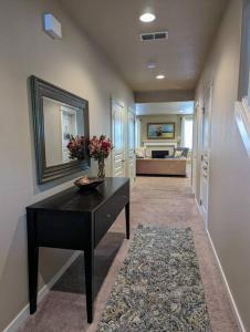 a hallway with a table and a mirror and a couch at Spacious 3-bedroom home with outdoor space in Eugene