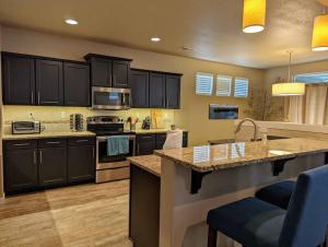 a kitchen with black cabinets and a counter top at Spacious 3-bedroom home with outdoor space in Eugene