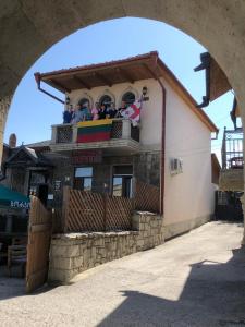 a group of people sitting on the balcony of a building at Golden Gate in Akhaltsikhe