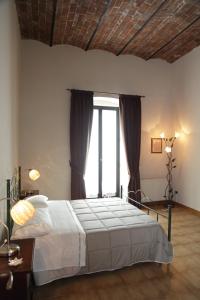 a bedroom with a bed and a large window at I Due Principi in San Marco Argentano