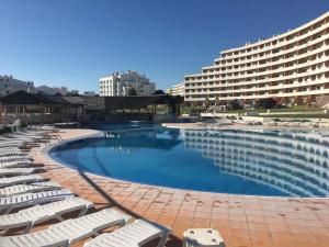 a large swimming pool next to a large hotel at Albufeira Paradise in Albufeira