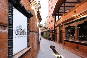 an alley with a sign on the side of a building at Dalai-La Boutique Hotel in Kathmandu