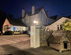 a house with a light on the side of it at Cookshayes Country Guest House in Moretonhampstead