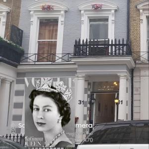 a advertisement of a woman with a tiara on a building at Anwar House in London