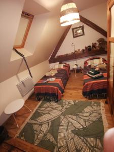 a room with four beds in a attic at Chambres d'hôtes aux portes de CHAMBORD in Vineuil