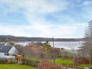 a view of a body of water from a house at Assynt Chalet - Uk30806 in Lochinver