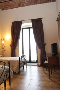 a bedroom with a bed and a large window at I Due Principi in San Marco Argentano +18 photos