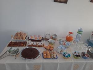 a table with food and desserts on it at CENTRAL ROOMS TORTOLI' in Tortolì
