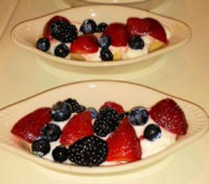 two plates of fruit with strawberries and blueberries at Granbury Gardens Bed and Breakfast in Granbury