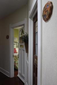 a hallway with a door leading to a bedroom at Granbury Gardens Bed and Breakfast in Granbury