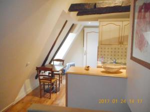 a kitchen and dining room with a counter and a table at Cité médiévale, charme & calme, bien placé in Sarlat-la-Canéda
