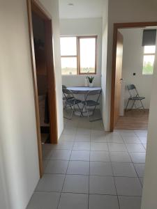 a hallway with a table and chairs in a room at Halakot guesthouse in Laugardælir