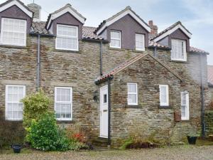 an old brick house with white windows at Secret View Cottage in Terrington