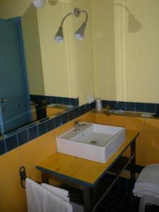 a bathroom with a sink and a mirror at Hotel Antonella in Caorle