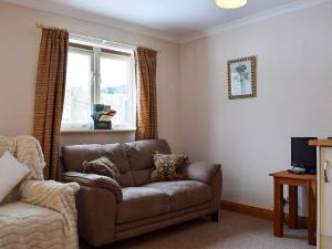 a living room with a couch and a window at Parsnip Place - Uk32606 in Manton
