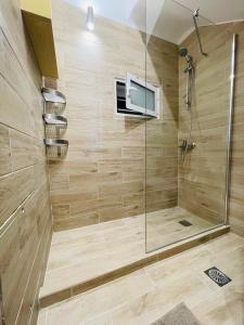 a bathroom with a shower with a television on the wall at Syllas Grand Resort - Executive View Villa 1 in Edipsos