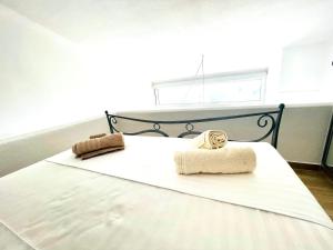a bedroom with a bed with two towels on it at Syllas Grand Resort - Executive View Villa 1 in Edipsos