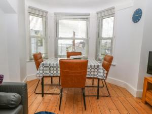 a dining room with a table and chairs at Y Castell Apartment 3 in Porthmadog
