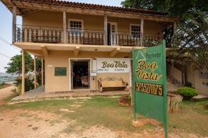 a house with a sign in front of it at Pousada Boa Vista in Tiradentes