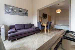 a living room with a purple couch and a table at Argyruntum Apartments in Starigrad-Paklenica