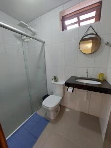 een badkamer met een douche, een toilet en een wastafel bij casaOCA in Lençóis