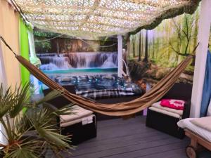 a hammock in a room with a waterfall at Sheri's Home away in Hither Green