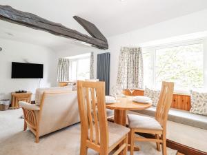 a dining room with a table and chairs at Woodloft Cottage in Elterwater