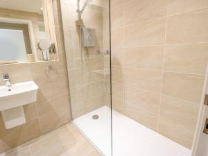 a bathroom with a shower and a sink at 3 Barn Cottages in Halifax +14 photos