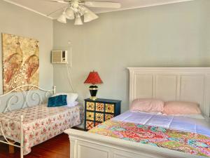 a bedroom with a bed and a ceiling fan at Madame Isabelle's House in New Orleans