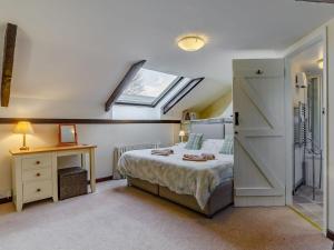 a bedroom with a bed and a skylight at The Tack Room - Uk30438 in Kingsbury Episcopi
