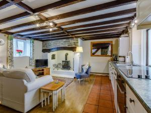 a kitchen and living room with a couch and a table at The Tack Room - Uk30438 in Kingsbury Episcopi