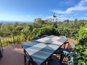 a table and chairs on a patio with a bird in the background at Ca di me in La Morra