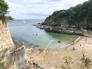 a group of people on a beach near the ocean at Rosie Cottage in Fowey