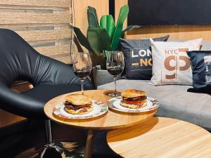 a table with two sandwiches and two glasses of wine at EL PAISAJE MAS SOÑADO in El Retiro