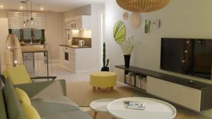 a living room with a couch and a tv at LUXURY MODERN apartment - Excellent location 50m from the beach, restaurants, bars, shops in Flic-en-Flac