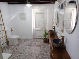 a bathroom with a toilet and a sink and a door at casa costa dorada con piscina in Creixell +21 photos