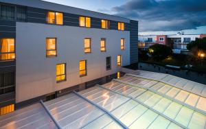a view of a building with a glass roof at Lagrange Apart'Hotel l’Escale Marine in La Rochelle