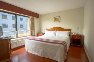 Letto o letti in una camera di MR Apart Providencia (ex Apart Neruda)