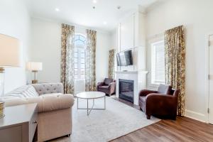 a living room with a couch and a fireplace at Chateau Renault in Egg Harbor City