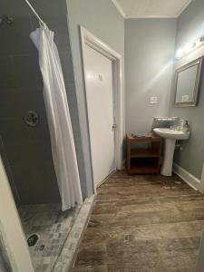 a bathroom with a shower and a sink at Best Rooming Houses in Rocky Mount NC. in Rocky Mount