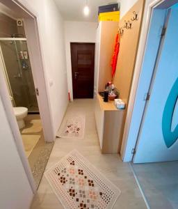 a bathroom with a shower and a tile floor at 1-Bedroom Apartment Fushë Kosovë in Kosovo Polje