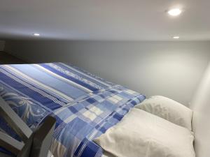 un letto in una camera con due cuscini sopra di Logement proche de l’aéroport CDG et parc des expo a Tremblay-en-France