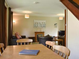 a room with a table and chairs and a living room at Trevithick Lodge in Hayle