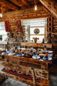 a table with plates of food on it in a cabin at Vidikovac Uvac in Družiniće