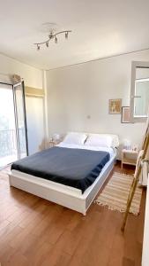 1 dormitorio con 1 cama grande con manta azul en Athens Taratsaki, en Atenas