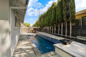 a swimming pool in the backyard of a house at Fully Renovated 4 Bedroom Home with Pool! in Roseville