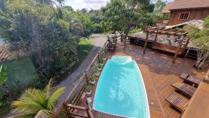 an overhead view of a swimming pool on a deck at Arte da Tribo Hostel & Camping in Praia do Rosa